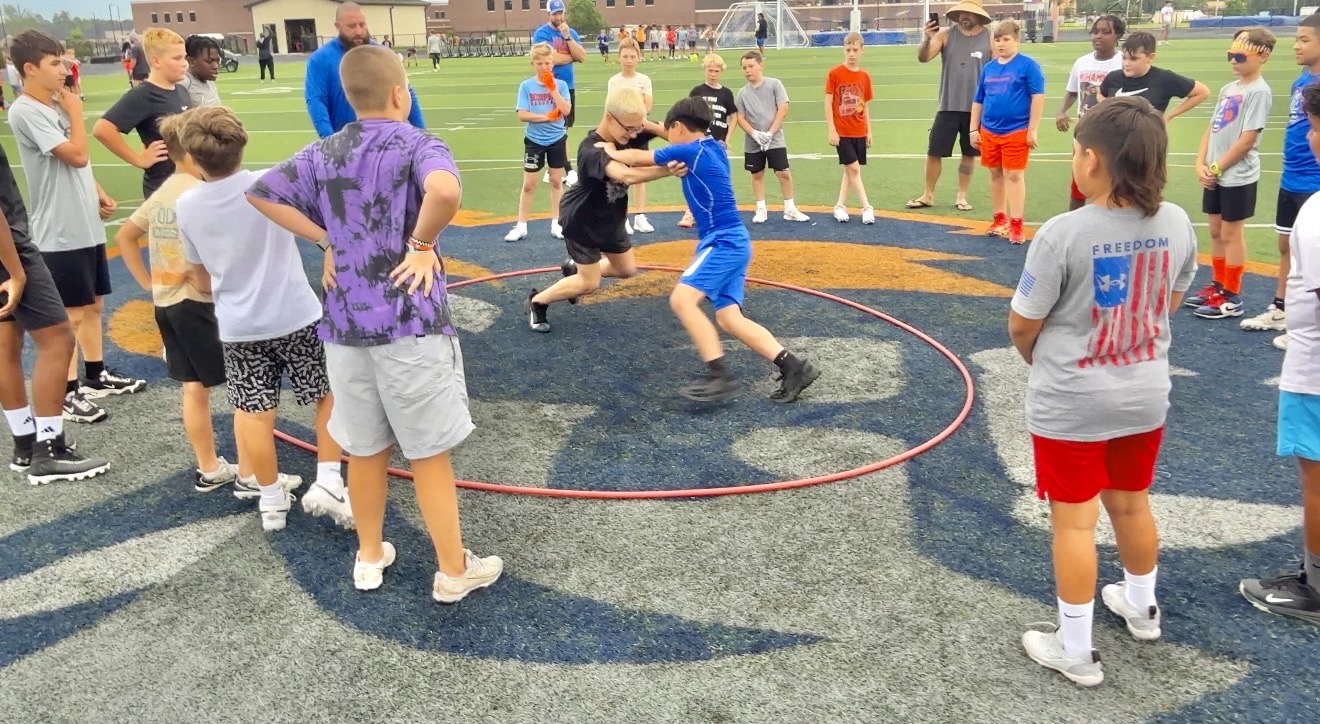 Young athletes competing in a structured football drill